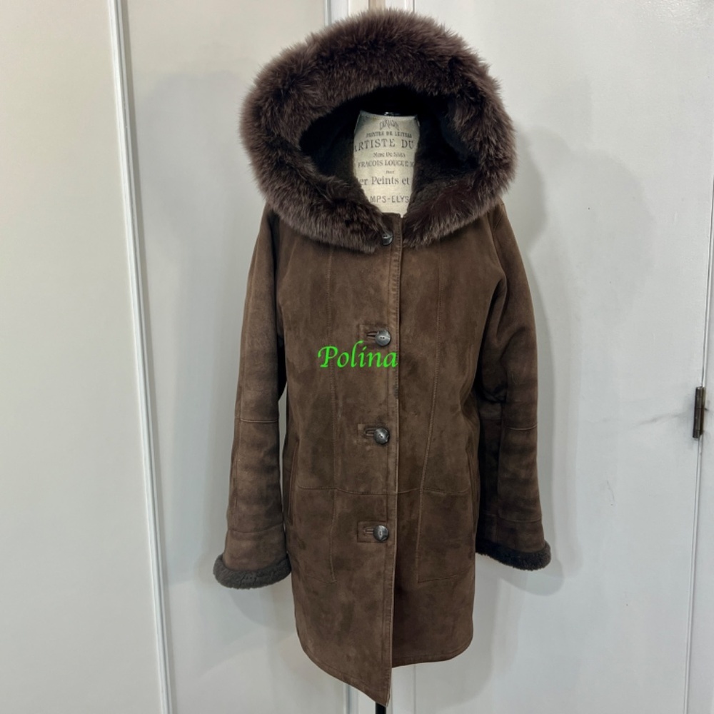 Brown medium length shearling lambskin coat. Hood is trimmed with real fox fur